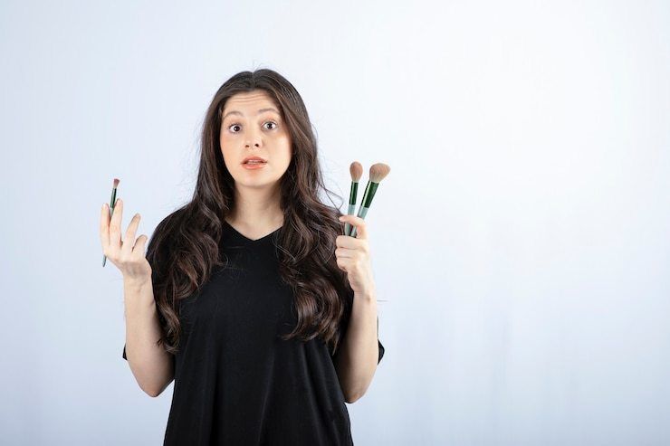 1644391448 portrait young girl with cosmetic brushes looking camera white 114579 52286