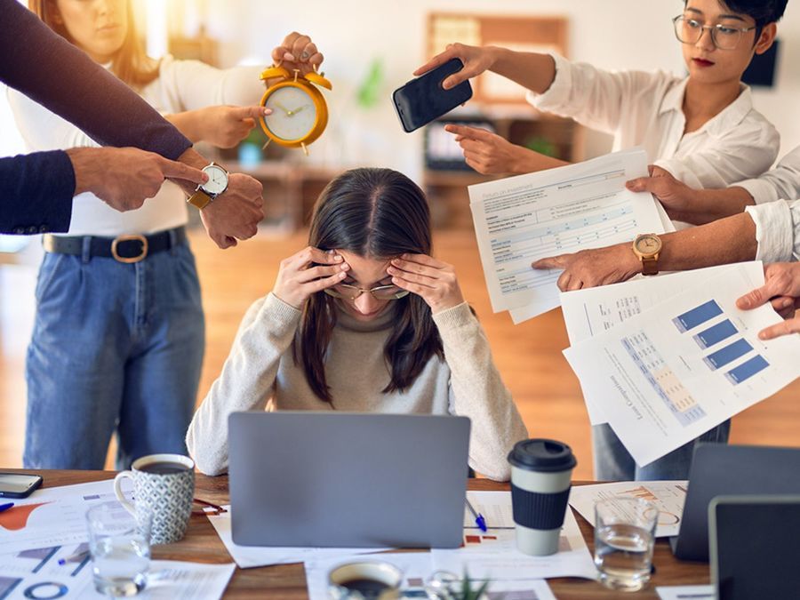 1682379674 woman stressed overwhelmed and overworked in her job