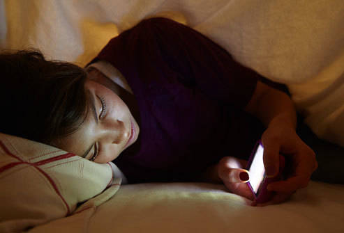1435653095 getty rm photo of teen girl texting in bed