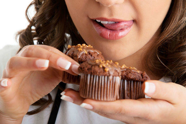 1466135269 young woman with chocolate muffin