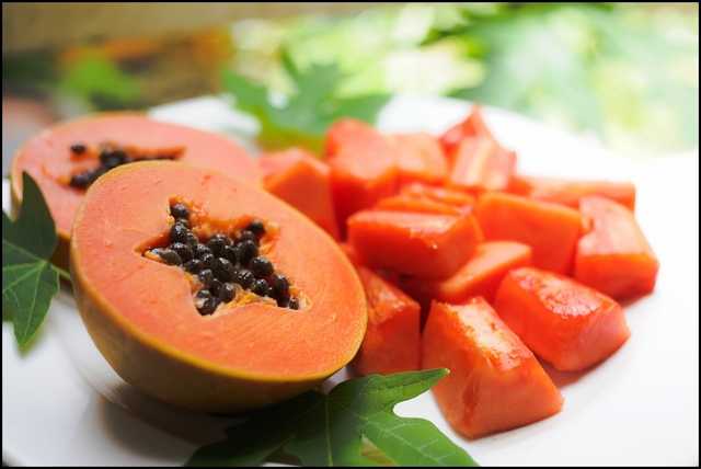 1466149202 sweet papaya on the dish with green papaya leaf