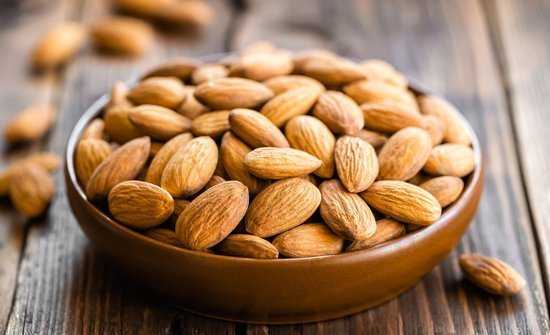 1466149829 almonds in a bowl on wooden table max