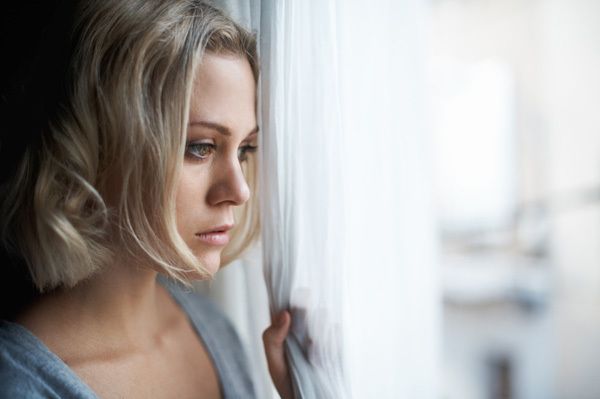 1467776696 sad woman looking out window1