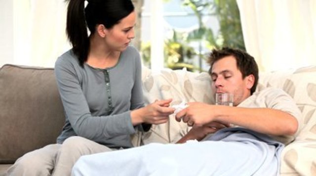 1429865208 stock footage worried woman giving pills to her sick husband 1