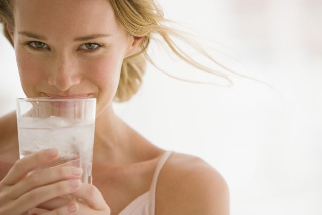 1470847299 woman drinking glass of water