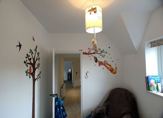 1470986229 winnie the pooh wall decal standsout thanks to the white backdrop