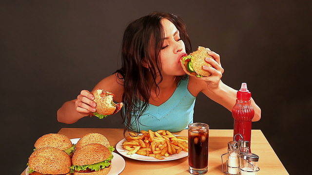 1438952397 stock footage woman eating fast food time lapse