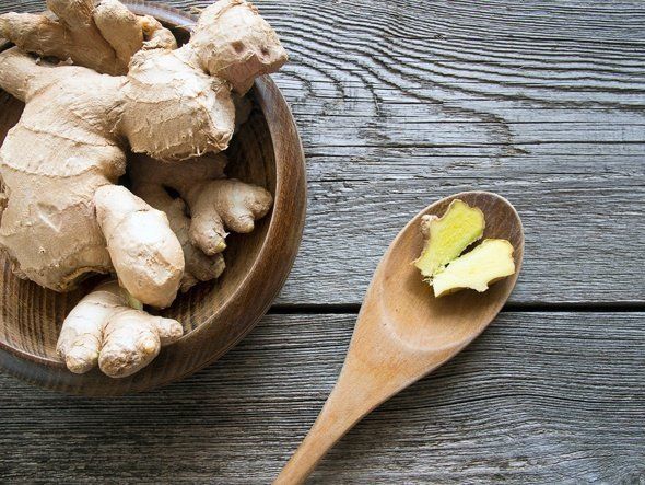 1481518540 ginger root in wooden bowl and spoon