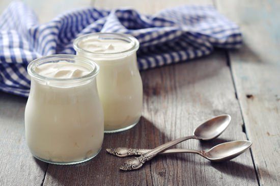 1481518575 jars of yogurt on a wooden table
