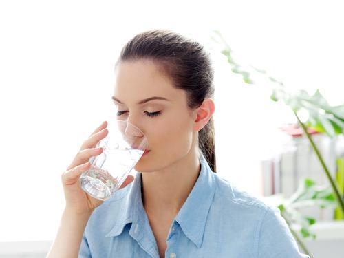 1483086900 woman drinking glass water morning