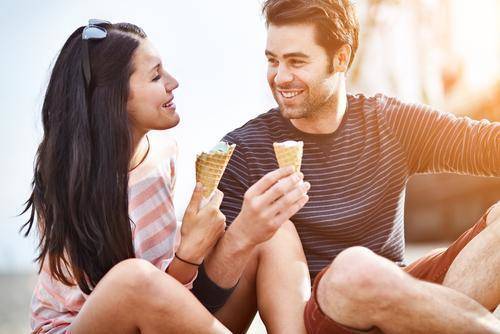 1441701792 couple amusement park eating ice cream and laughing