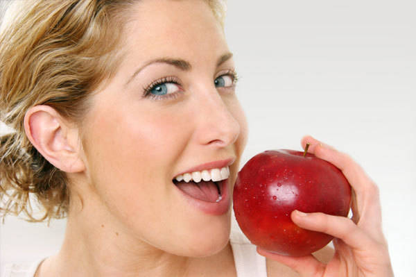 1441790892 happy woman eating red apple