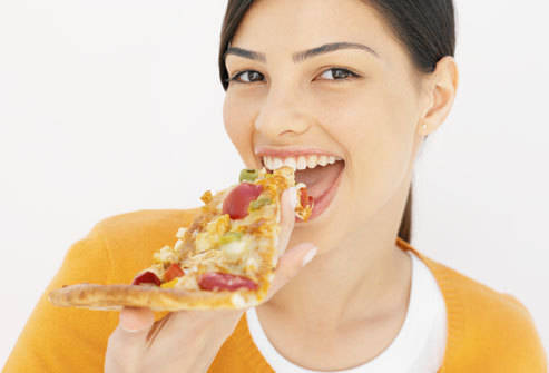 1441791307 getty rf photo of teen eating pizza