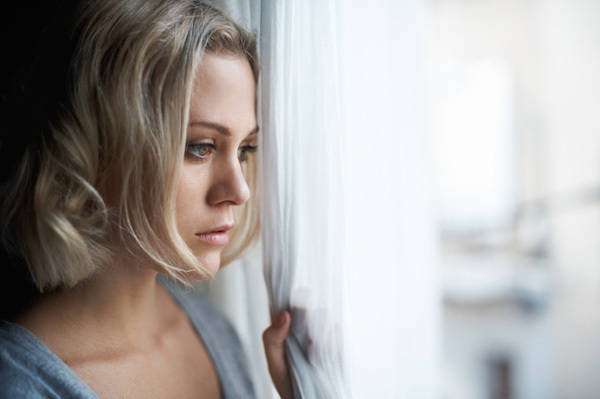 1442196992 sad woman looking out window1