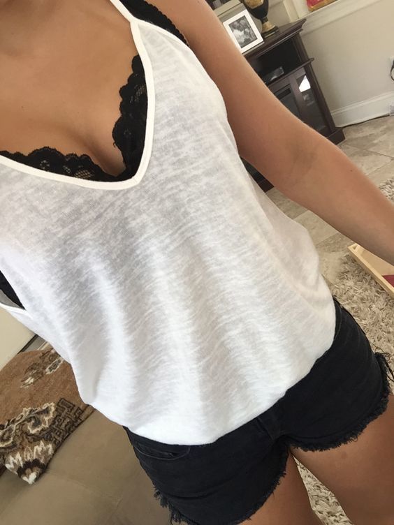1500378549 08 a black lace bralette under a semi sheer white top with black denim shorts