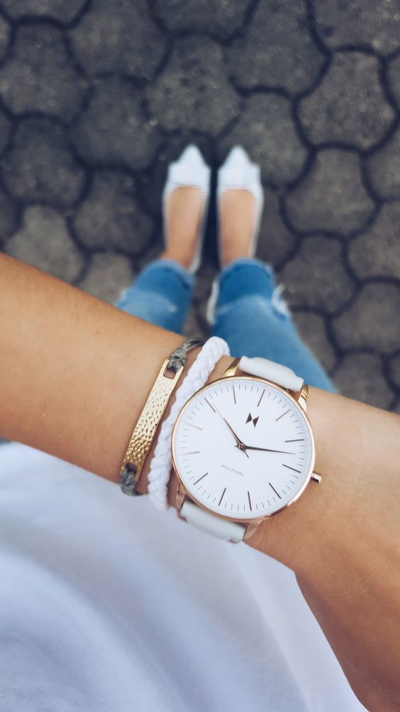 1503617936 12 a large watch on a white leather band with a couple of matching bracelets accentuates your look