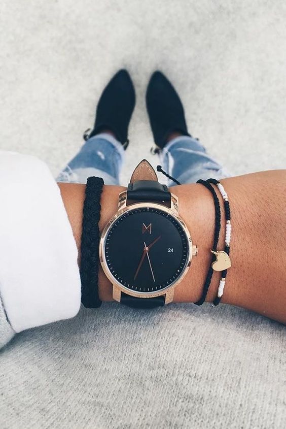 1503617969 13 a black watch with a couple of matching bracelets of twine and beads