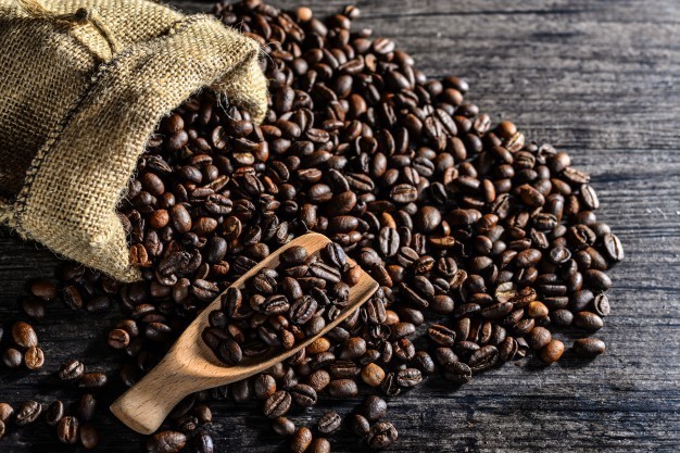 1509963936 top view of wooden spoon and a canvas bag of coffee beans 1112 441