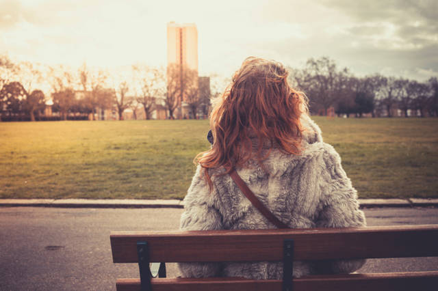 1447409128 woman sitting alone on park bench
