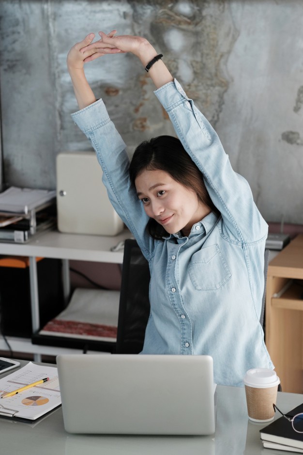 1522814110 asian office woman stretching body for relaxing while working with laptop 7190 1487