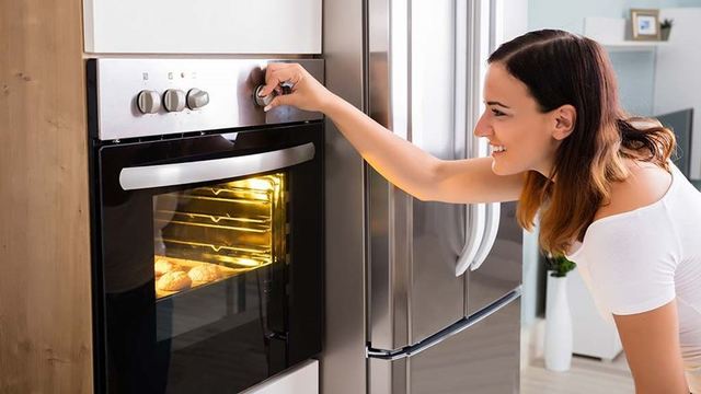 1522833695 woman using oven controls