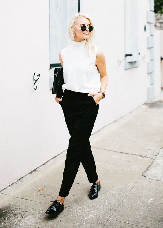 1523594980 04 black pants a sleeveless high neckline top black lacquered leather shoes