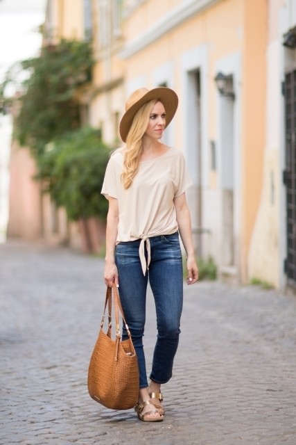 1527824438 with beige shirt wide brim hat jeans and brown bag