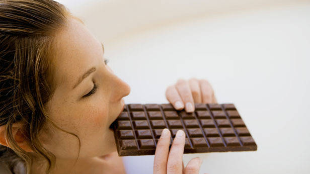 1450092550 person eating chocolate