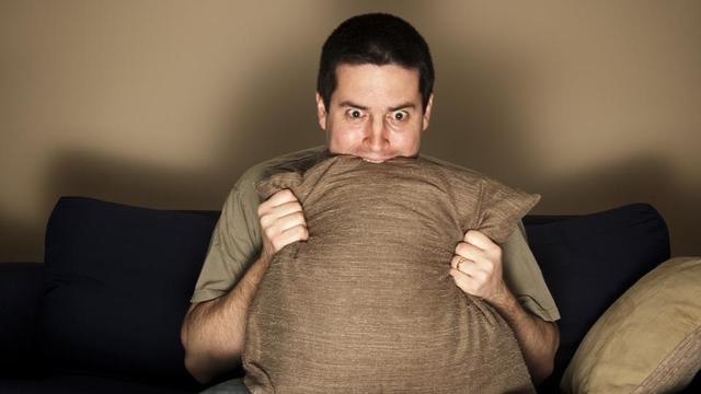 1528904472 man bites pillow in fear while watching 4be4b150 5f08 11e7 a7a5 fdf01393e65b