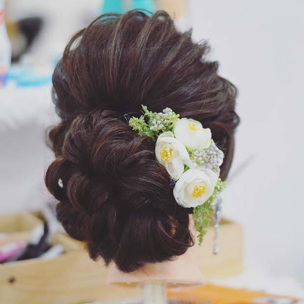 1548045995 low bun with floral accessory