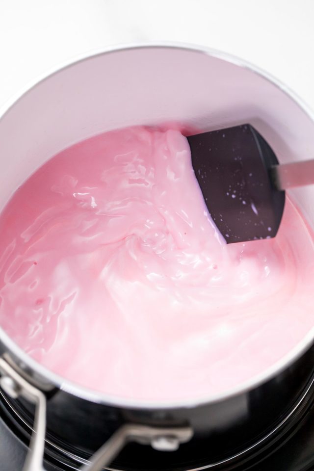 1549008005 5d4b2998 unicorn hot chocolate mixing milk with food coloring using a spatula in a pot 1200x1800