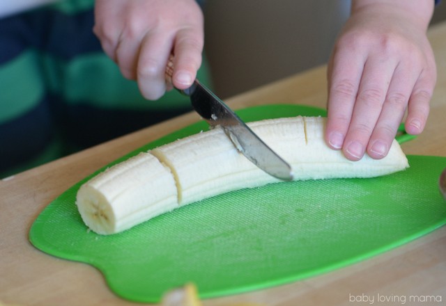 1549603798 three year old slicing bananas