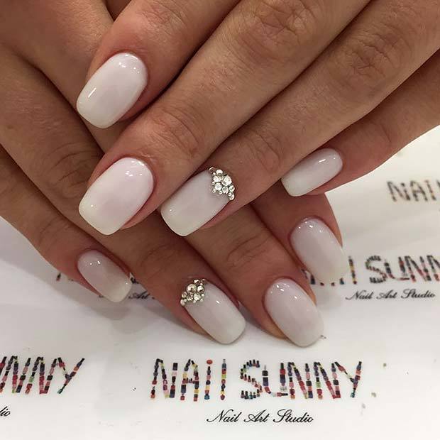 1550210044 chic white nails with crystal design