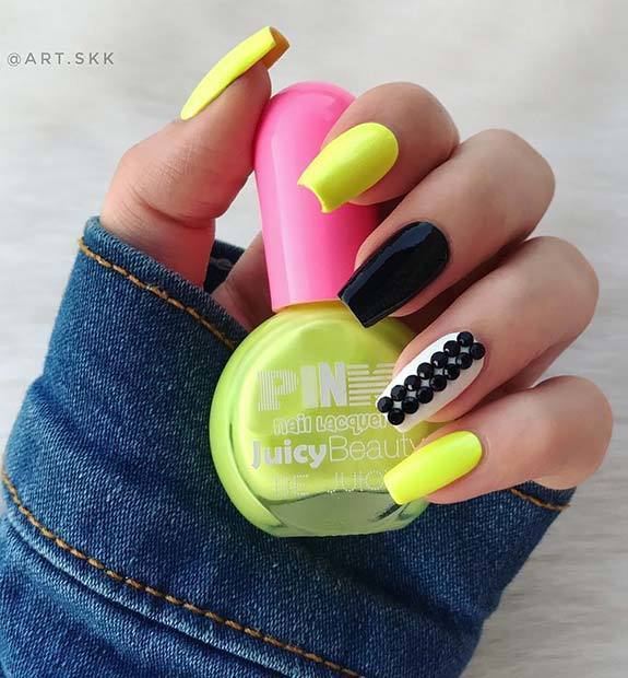 1552887166 black and yellow nails with embellished accent nail