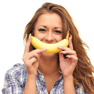 1466045671 1459324686 girl isolated on white background holding a banana near the mouth