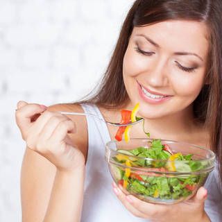 1470195727 1444030484 woman laughing alone with salad