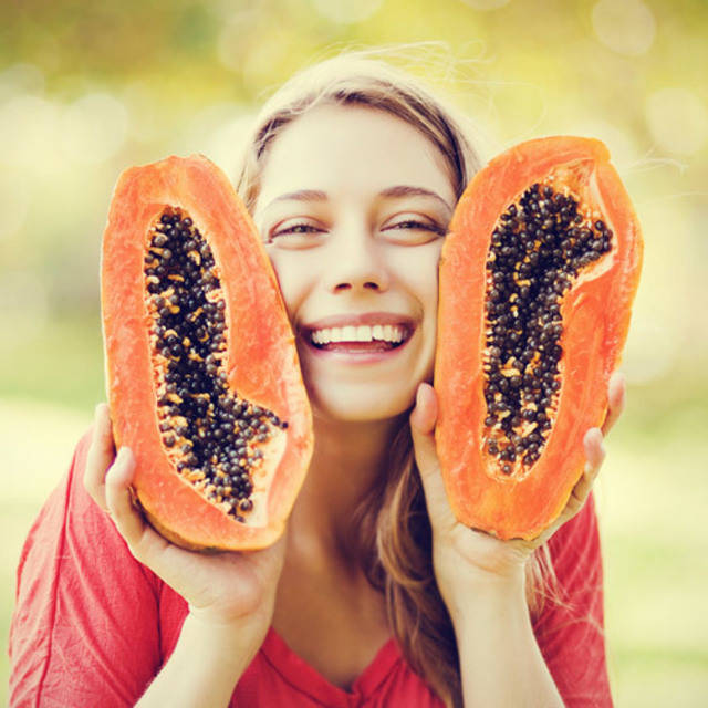 1466045054 young woman smiling with papaya