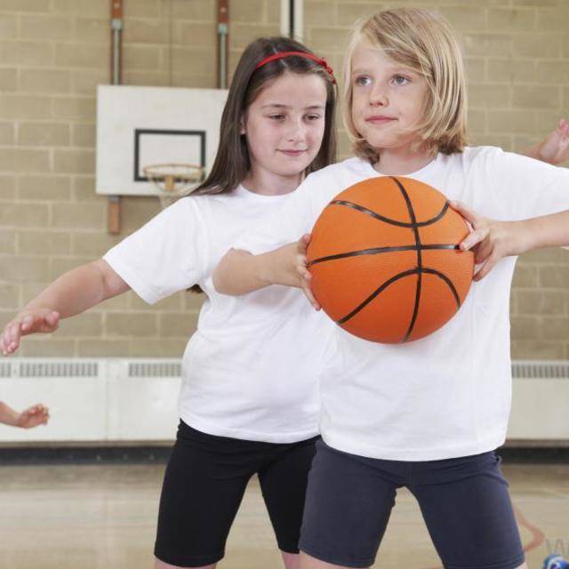 1444796639 two girl in white shirts near boys playing basketball