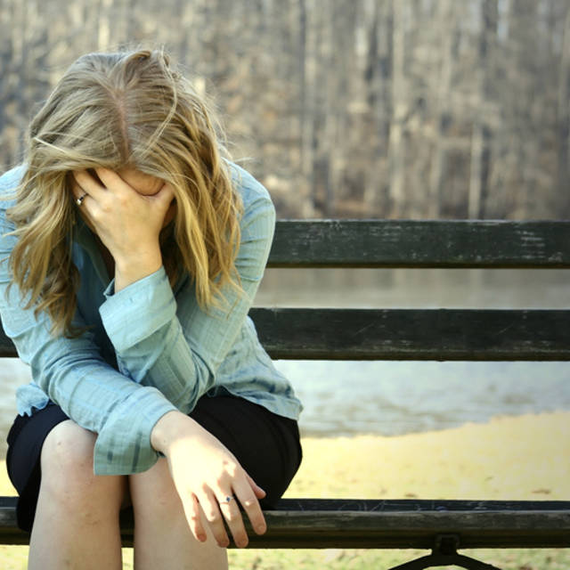 1436210878 sad girl on bench 28200291
