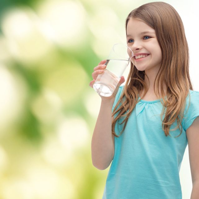 Girl drinking water outside