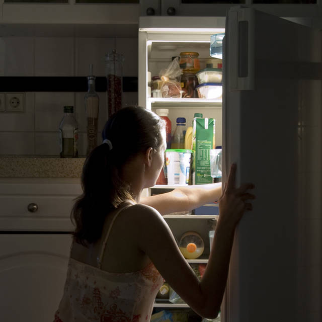 1437629776 woman eating late night fridge