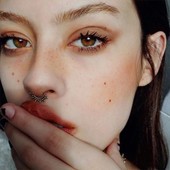 Icon retro 90s grunge makeup look pale glow red lips red blush and red hues around the eyes