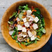Icon spinach tofu and shaved carrot salad with sesame dressing and spiced pepita and cashew crunch