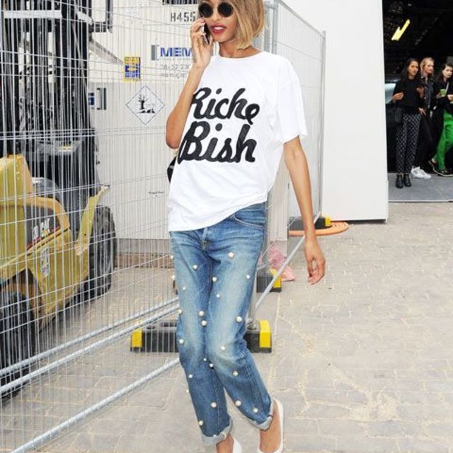 02 an oversized printed tee blue cuffed jeans with large pearls and white shoes