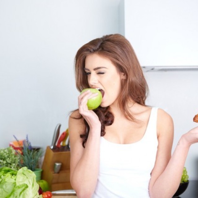 Diet. dieting concept. healthy food. beautiful young woman choosing between fruits and sweets  629x420