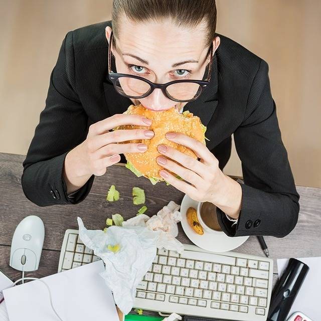 1448594930 woman eating at work desk