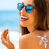 Icon woman applying sunscreen on the beach 2