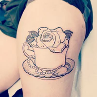 https://image.sistacafe.com/w200/images/uploads/content_image/image/223496/1475570757-Outline-Rose-And-Simple-Teacup-Tattoo-On-Left-Thigh.jpg
